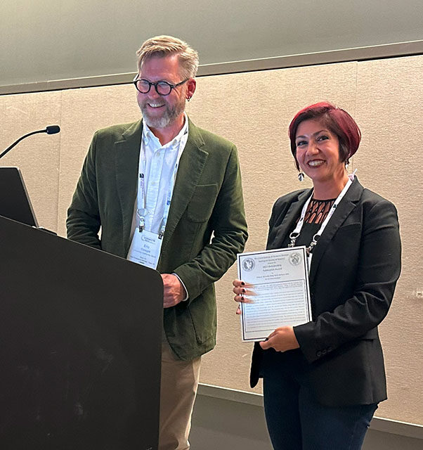 CSUN structural geologist Elena Miranda accepting the Geological Society of America’s Structural Geology and Tectonics Division for its highest publication honor, the Structural Geology and Tectonics Division Outstanding Publication Award, from Eric Cowgill of UC Davis. Photo courtesy of Elena Miranda.