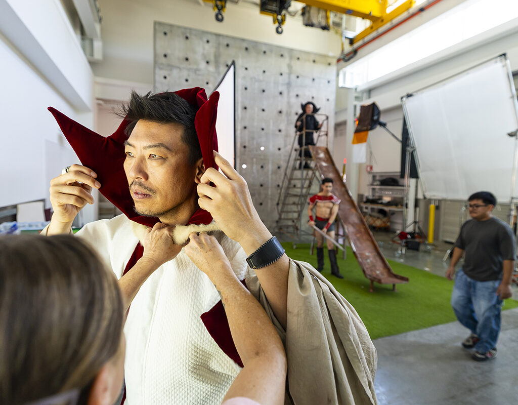 A man gets his Ming the Merciless costume adjusted during a photo shoot.
