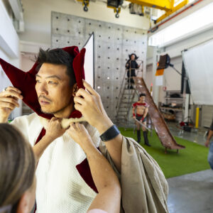 A man gets his Ming the Merciless costume adjusted during a photo shoot.