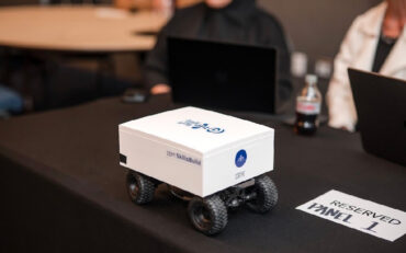 A white container on four wheels with IBM SkillsBuild written on the side.