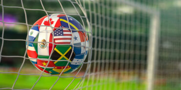 Soccer Football ball with flags of North America countries in net on football stadium. 3d illustration