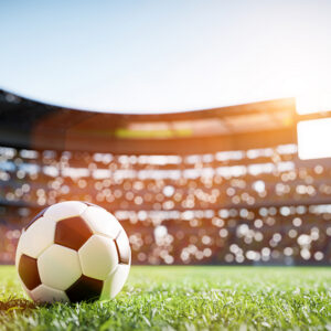 Soccer ball on grass field on stadium