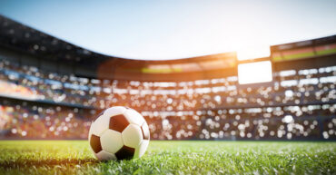 Soccer ball on grass field on stadium
