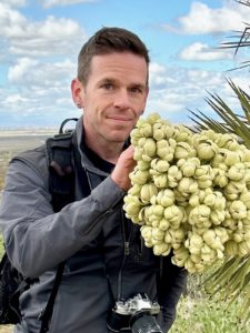 Jeremy Yoder with a flowering Joshua tree.