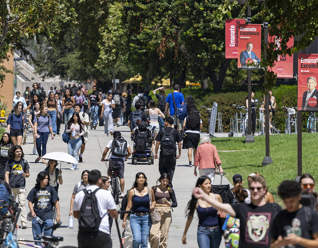 Students walk on campus sidewalks.