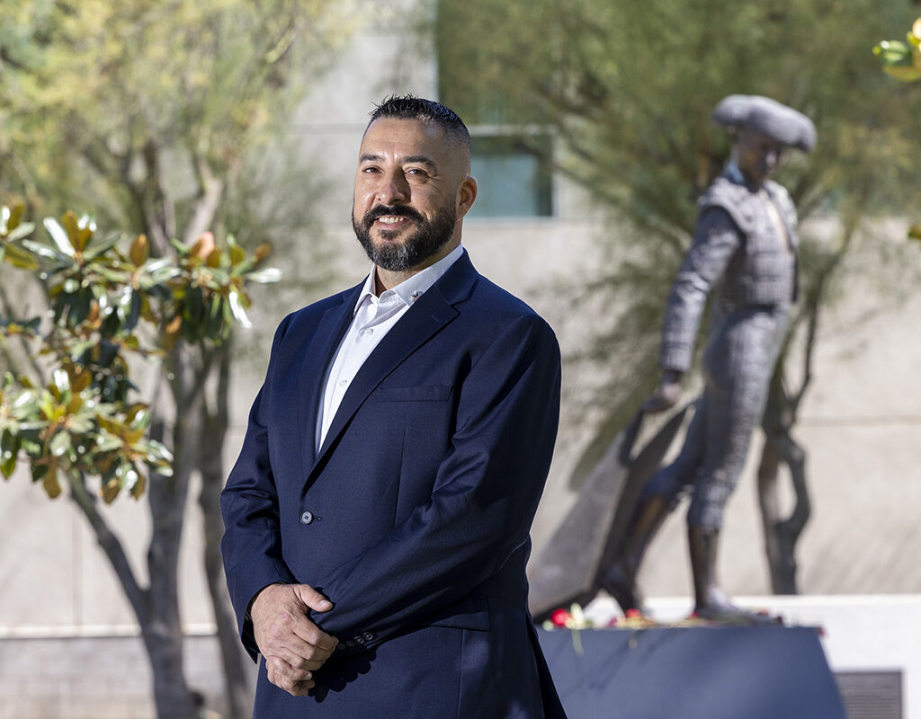 Hector Gonzalez stands on campus with the Matador statue in the background.