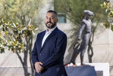 Hector Gonzalez stands on campus with the Matador statue in the background.