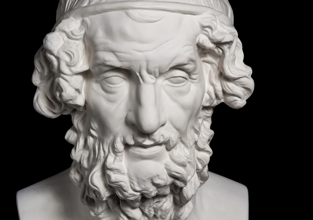 White gypsum copy of ancient statue of Homer head for artists isolated on a black background. Plaster sculpture of man face.