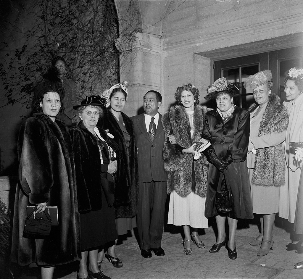 Juanita Miller (third from left), Langston Hughes and Dorothy Vena Johnson (fifth from left), along with a group of women. Los Angeles, January 1946. Photo by Vera Jackson. © CSUN Tom & Ethel Bradley Center.