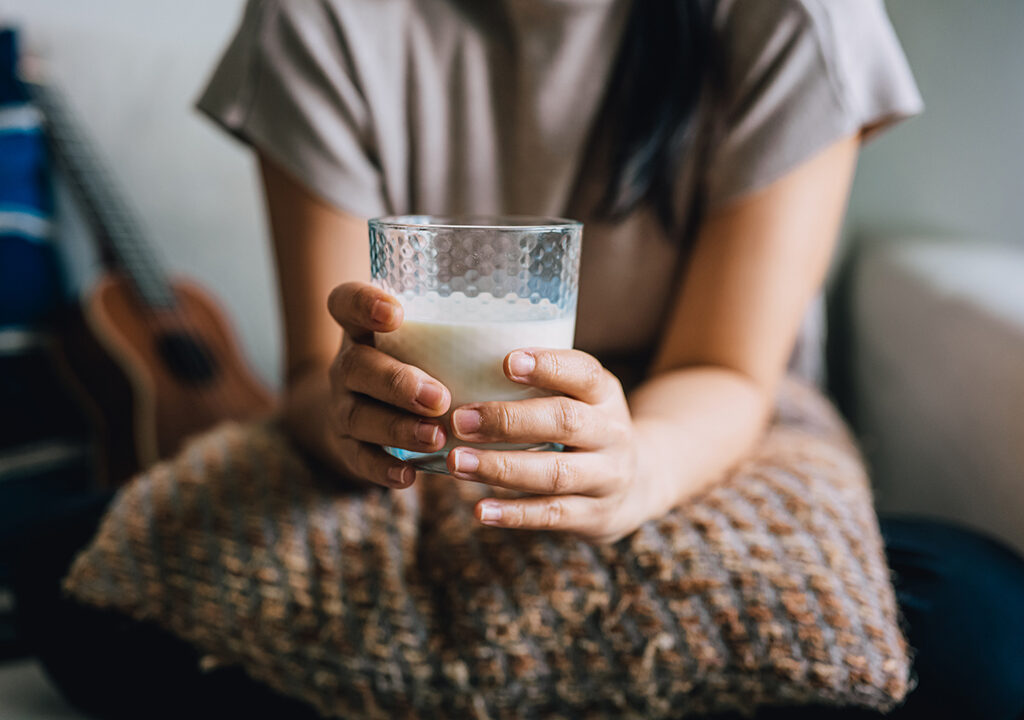 Woman holds glass of milk