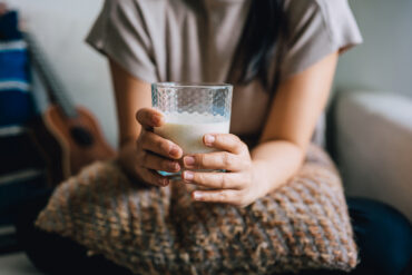 Woman holds glass of milk